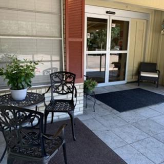 A cozy entrance with chairs and a table, perfect for relaxing outdoors.