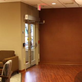 A lobby interior with seating and an exit door.