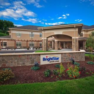 A healthcare facility with a BrightStar sign, set against a clear blue sky and landscaped surroundings.