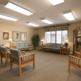 A cozy waiting room featuring comfortable seating and warm lighting.