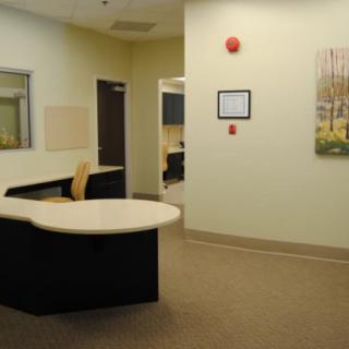 An office reception area featuring a desk and seating.