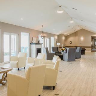 A spacious and modern lounge with comfortable seating.