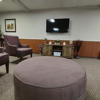 A cozy living room setup featuring comfortable chairs and a television.