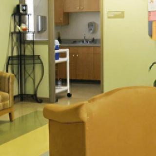 A cozy waiting area with comfortable chairs and a view of a kitchenette.