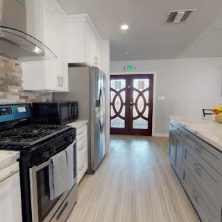 A modern kitchen with stainless steel appliances and stylish cabinetry.
