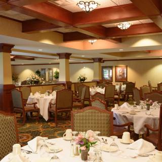 An elegant restaurant dining area with neatly arranged tables and chairs.