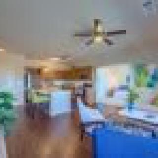 A spacious open-concept living area featuring a modern kitchen and dining space.