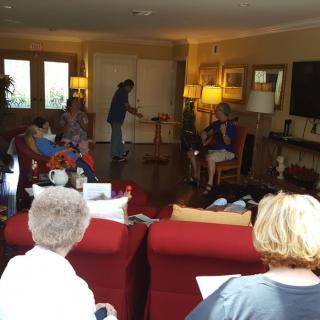 A group of people gathered in a cozy living room, enjoying an informal meeting.