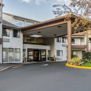 The image shows the entrance of a multi-story residential building.