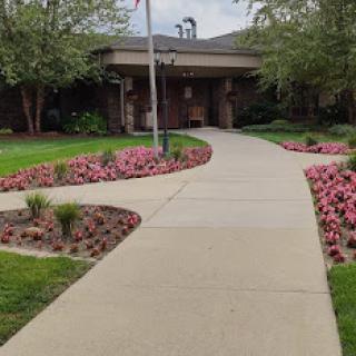 A picturesque walkway through a beautifully landscaped garden.