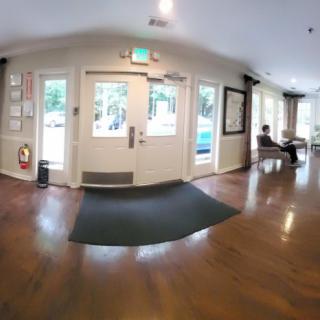 A spacious lobby area with a seating section and large windows.