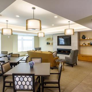 A modern, well-lit living and dining area with stylish decor and comfortable seating.
