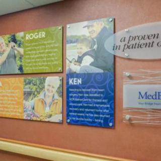 Hospital hallway featuring patient stories and testimonials displayed on the wall.