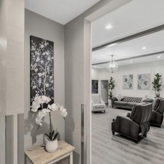 A modern living room with neutral tones, featuring comfortable seating and elegant decor.