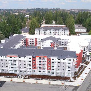Aerial view of a modern apartment complex in an urban setting.