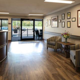 A welcoming office lobby with comfortable seating and wall decorations.