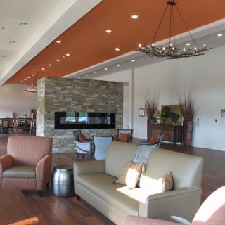 A modern lounge with comfortable seating and a fireplace.