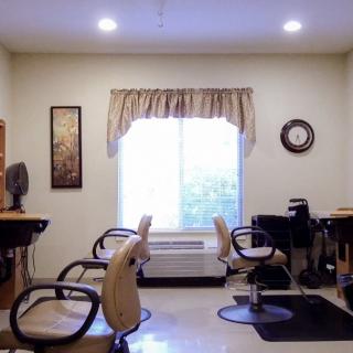 A cozy hair salon setup with two styling stations and natural light.