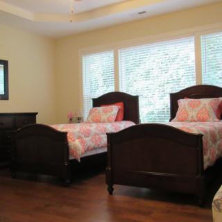 A cozy bedroom with twin beds and ample natural light.