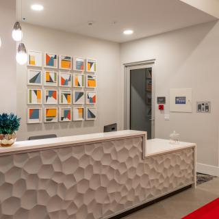 A modern reception area featuring geometric decor and contemporary artwork on the wall.
