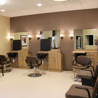 A well-organized salon space with styling chairs and mirrors.