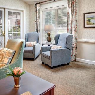 A cozy living room with comfortable armchairs and elegant decor.