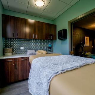 A tranquil massage room with a treatment table and soothing interior design.