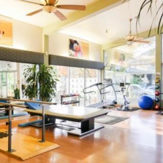 A modern gym interior with fitness equipment and bright lighting.