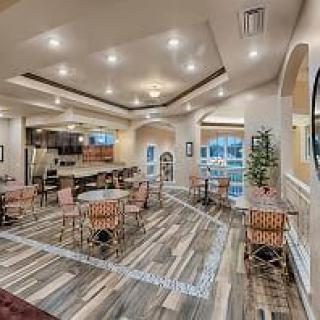 A modern dining and kitchen area with stylish decor and warm lighting.