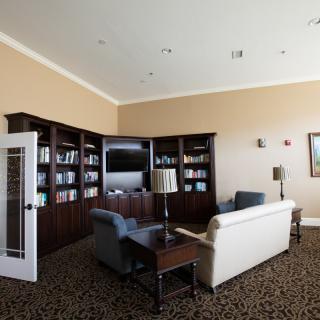 A cozy living room with bookshelves, a sofa, and a television.
