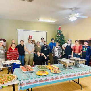 A cheerful gathering of friends and family celebrating the holiday season with a festive meal.