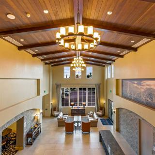 Spacious lobby with high ceilings and elegant chandeliers.