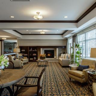 A cozy, spacious living room with elegant furniture and a fireplace.