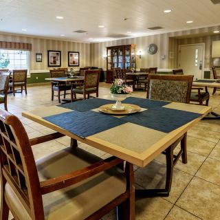 A spacious dining room with neatly arranged tables and chairs.