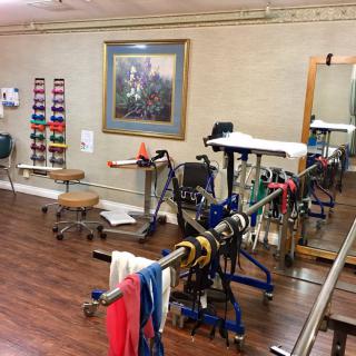 A physical therapy room equipped with various rehabilitation tools and exercise machines.