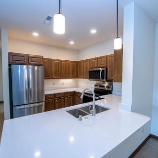 A modern kitchen featuring sleek appliances and a spacious countertop.