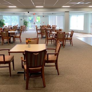 An empty dining area with neatly arranged tables and chairs.