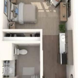 Studio apartment floor plan with open living space, kitchen, bedroom, and bathroom.