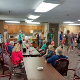 A lively gathering in a community space with people engaging and socializing.