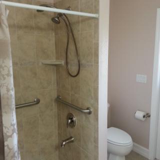 An accessible bathroom with a shower and toilet.