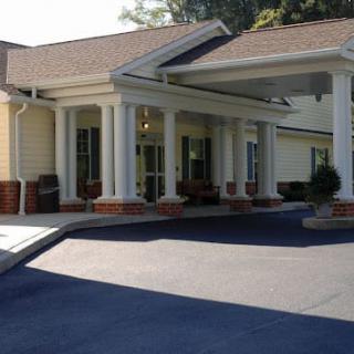 A building entrance with columns and a covered driveway.
