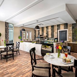 A cozy cafe interior with tables and chairs set for dining.