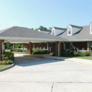 A suburban house with a driveway and covered entrance.