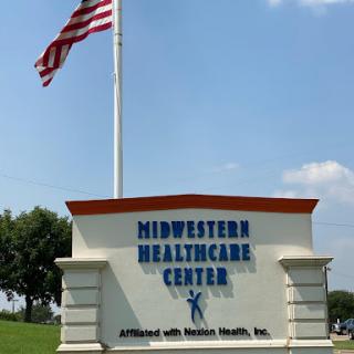 Signage for Midwestern Healthcare Center with an American flag in the background.