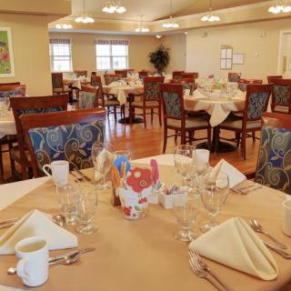 A well-arranged dining area with neatly set tables and chairs.