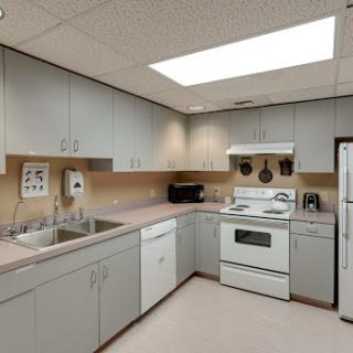 A modern kitchen equipped with essential appliances and ample storage.