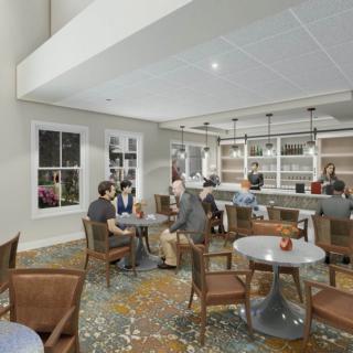 A modern cafe interior with people seated at tables and a bar counter.