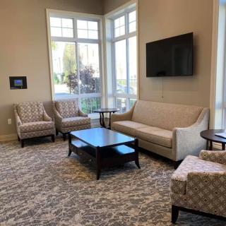 A cozy living room setup with comfortable seating and a large window letting in natural light.