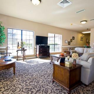 A well-lit living room with comfortable furniture and elegant decor.