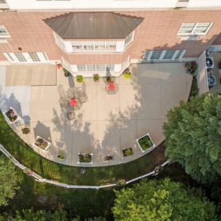 Aerial view of a house patio with landscaping and outdoor furniture.
